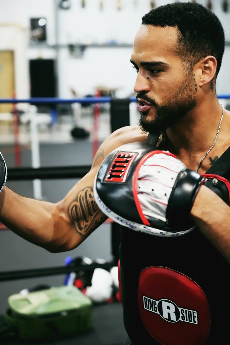 Jeremiah Sierra holding mitts at Toe 2 Toe Boxing in Salem